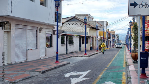 Person riding a bicycle in a hazmat suit in Cotacachi, Ecuador, during the COVID-19 lock-downs of 2020