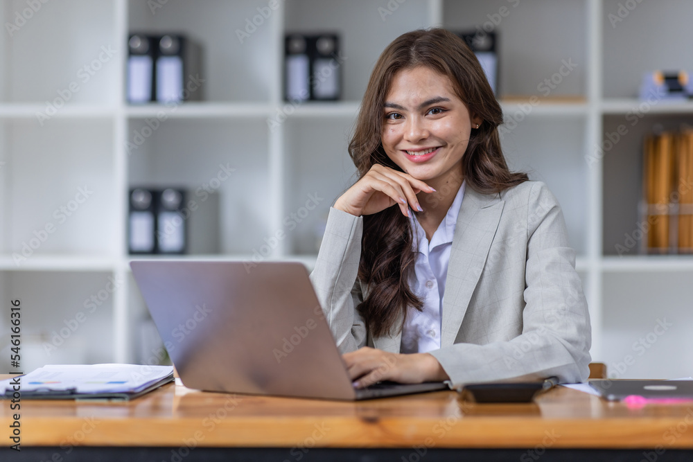 Young business Asian woman Accounting using calculating income-expenditure and analyzing real estate investment data report Financial and tax systems concept. Young business Asian woman Accounting using calculating income-expenditure and analyzing real estate investment data report Financial and tax systems concept.