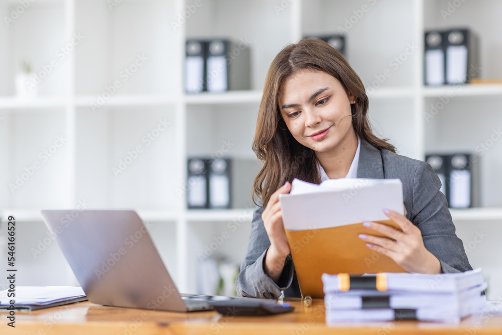 Young business Asian woman Accounting using calculating income-expenditure and analyzing real estate investment data report Financial and tax systems concept.	