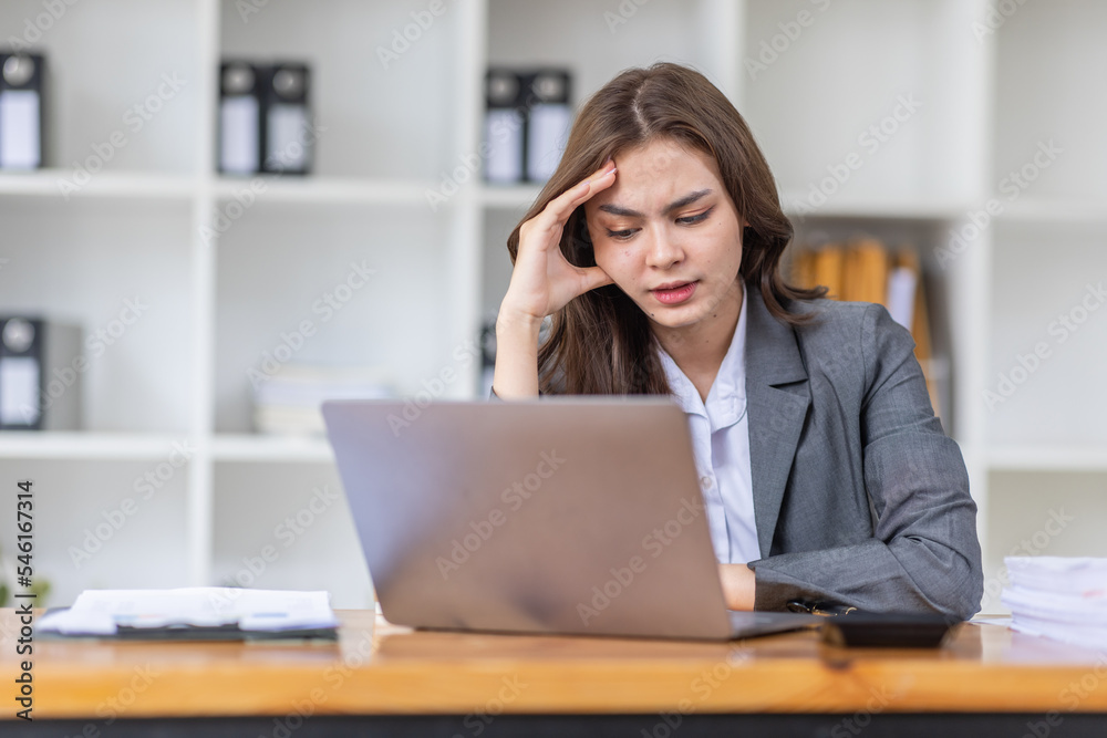 Young business Asian woman stressed while working, Tired asian businesswoman with headache at home office, payment stressed and confused by calculate expense from invoice or bill tax.
Young business Asian woman stressed while working, Tired asian businesswoman with headache at home office, payment stressed and confused by calculate expense from invoice or bill tax.