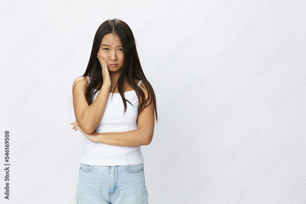 Asian woman hand signals, finger pointing facial skin problems, acne and inflammation, red rash and allergies, chicken pox, sadness from rashes. Facial skin care concept for diseases and nerves Asian woman hand signals, finger pointing facial skin problems, acne and inflammation, red rash and allergies, chicken pox, sadness from rashes. Facial skin care concept for diseases and nerves