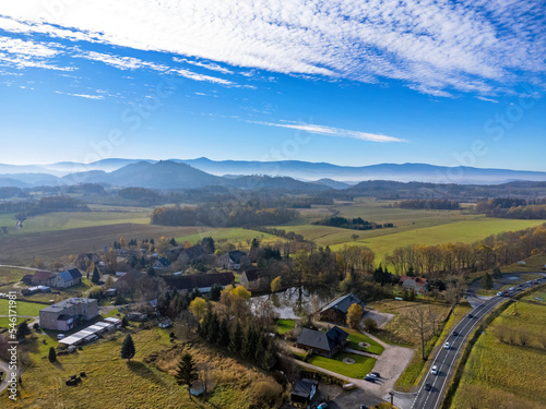 Obraz na płótnie Aerial view of charming small town in Poland. Mountains with fall multicolor trees and beaufitul sky. w salonie