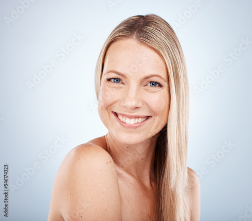 Beauty  portrait and face of a woman for skincare  health and wellness against a grey studio background. Front cosmotology and skin care or bodycare for a female with soft  smooth skin