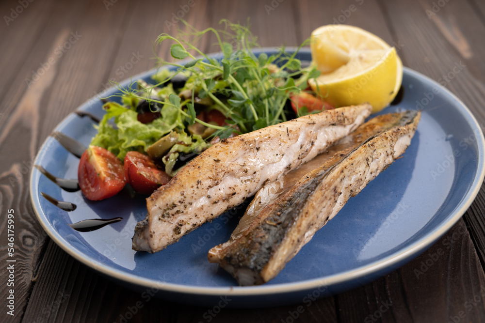 BBQ Grilled mackerel fish with lemon and tomatoes on plate. Menu restaurant BBQ Grilled mackerel fish with lemon and tomatoes on plate. Menu restaurant