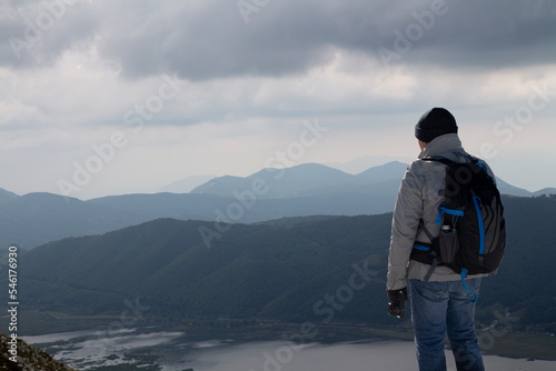 Hiker on the summit of a mountain and lake