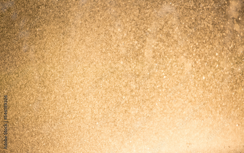 Drops of water splatter fly with yellow golden rays of the sun at sunset concept of freshness drink, watering the rain source of clean water fountain, copy space Drops of water splatter fly with yellow golden rays of the sun at sunset concept of freshness drink, watering the rain source of clean water fountain, copy space