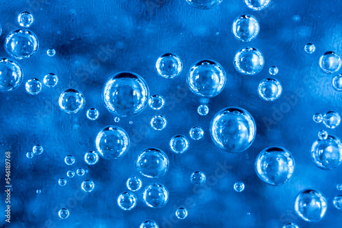 Bubbles in carbonated water. Background of water with bubbles closeup, soda. Refreshing cool drink.