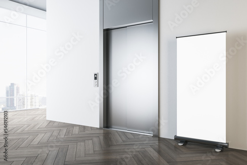 Stampa su tela Perspective view on blank white poster on wooden parquet floor in sunlit modern office hall with light wall, metallic elevator doors and city view from panoramic windows