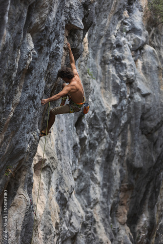 rock climber climbs the rock.