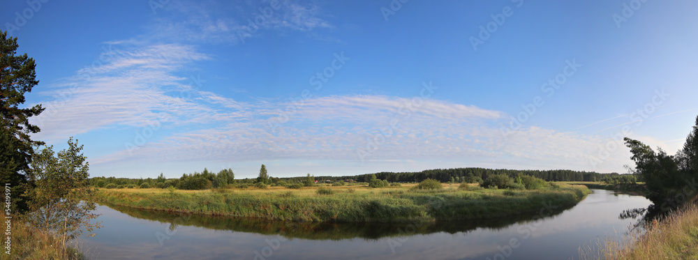 Panorama of calm river under blue sky