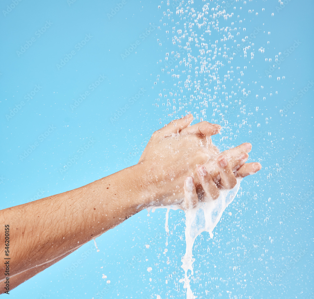 Cleaning hands, water splash and wash for hygiene, healthcare and wellness mockup on a blue studio background. Skin hydration, moisturizing skincare skin and protect from bacteria, germs and disease