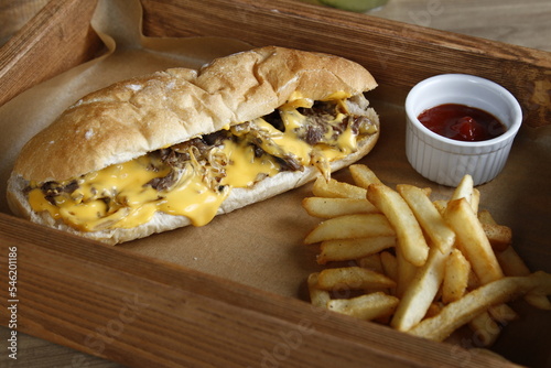 Philly cheesesteak with French fries and ketchup, lemonade