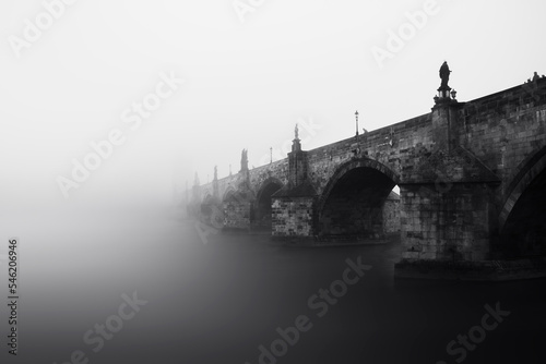 Photography Charles bridge over Vltava river in the fog in the morning