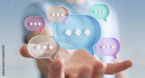 Businessman using digital speech bubbles talk icons. Minimal conversation or social media messages floating over user hand. 3D rendering