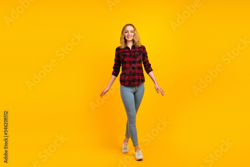 Full length view of nice-looking dreamy cheerful glad wavy-haired girl waking isolated on bright color background