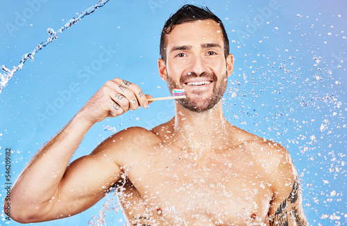 Man, toothbrush and smile for dental care, hygiene and cosmetics against an aqua blue studio background. Portrait of happy male smiling with teeth for clean oral wash, mouth or gum care treatment