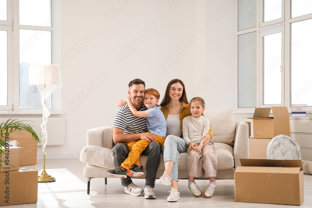 Happy family sitting on couch in new apartment. Moving day Happy family sitting on couch in new apartment. Moving day