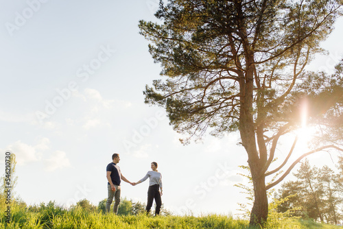 A young couple in love walks in the woods, having a good time together