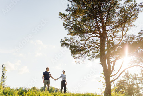 A young couple in love walks in the woods, having a good time together