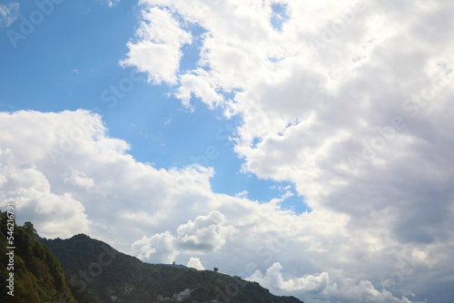 Picturesque view of mountain under beautiful sky with fluffy clouds