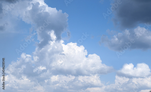 Beautiful fluffy clouds on light blue sky as background