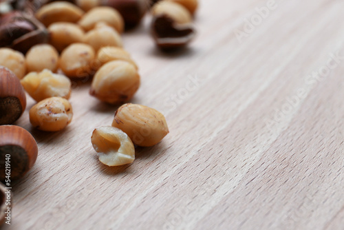 Tasty organic hazelnuts on wooden table, closeup. Space for text
