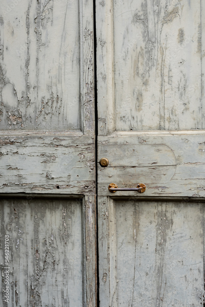 old grey wooden door with lock and handle, close up, background, texture