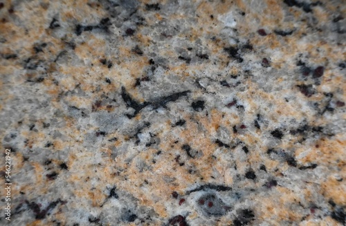 Fondo con detalle y textura de superficie de marmol jaspeado con tonos marrones, grises y negros