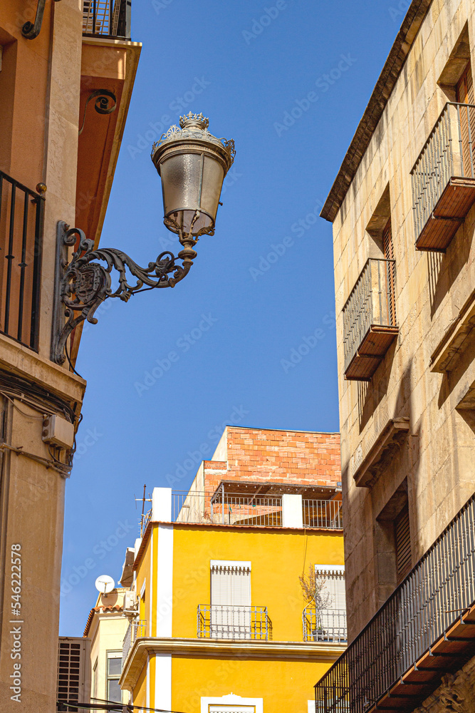 Street of a European city. Beautiful lantern against the sky
