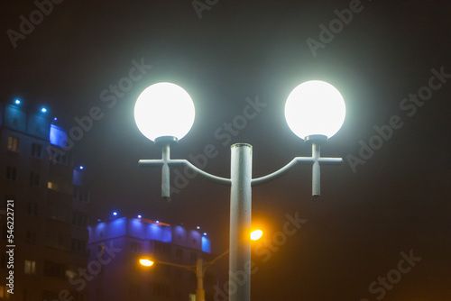 City street lights on the background of the house in the evening