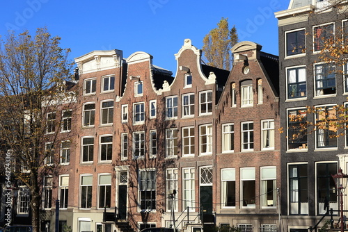 Amsterdam Prinsengracht Canal Traditional Brick House Facades with Various Gables and Blue Sky, Netherlands