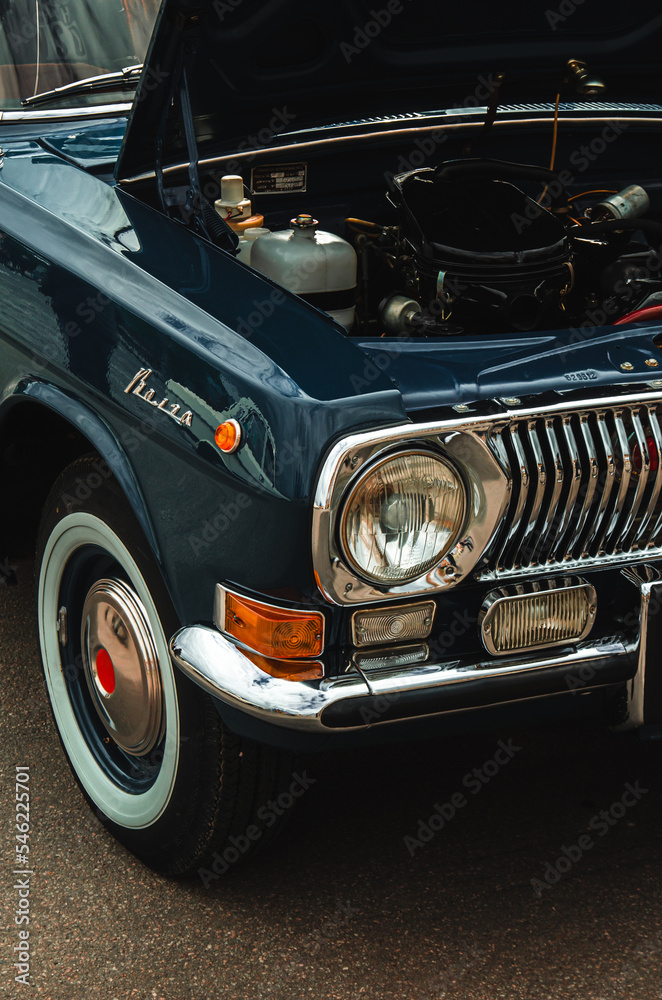 old classic car with an open hood at the exhibition