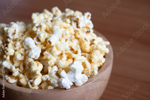 Popcorn in a wooden cup. Snacks.