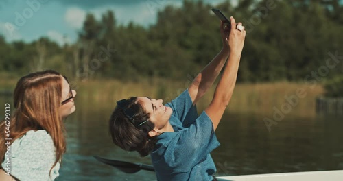 Young female couple taking a selfie in a canoe