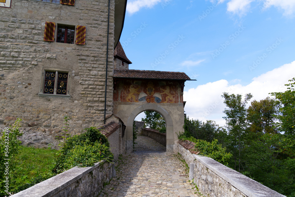 Kyburg castle with stone gate,, stone bridge and coat of arms on a sunny late summer day. Photo taken September 1st, 2022, Kyburg, Switzerland.