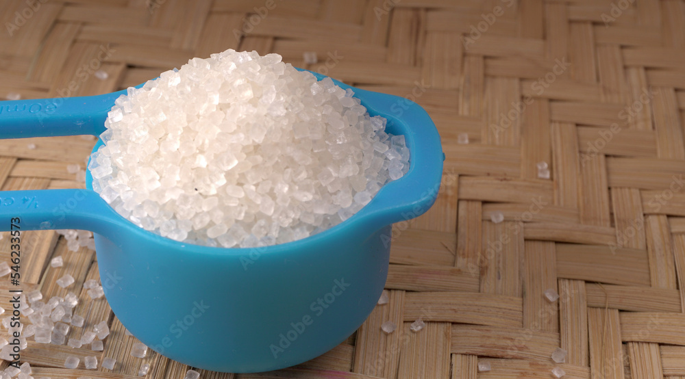Bowl and spoon with sugar on wooden background. Bowl and spoon with sugar on wooden background.