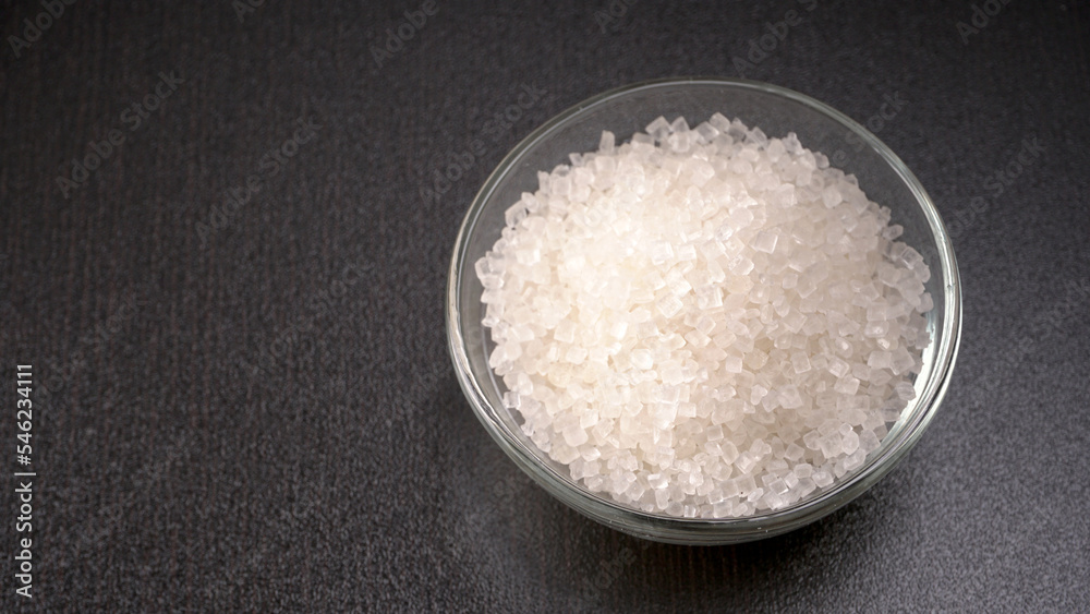 Bowl and spoon with sugar on wooden background. Bowl and spoon with sugar on wooden background.