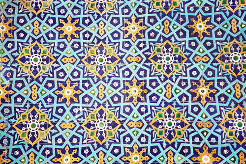 Traditional uzbek pattern on the ceramic tile on the wall of the mosque. photo