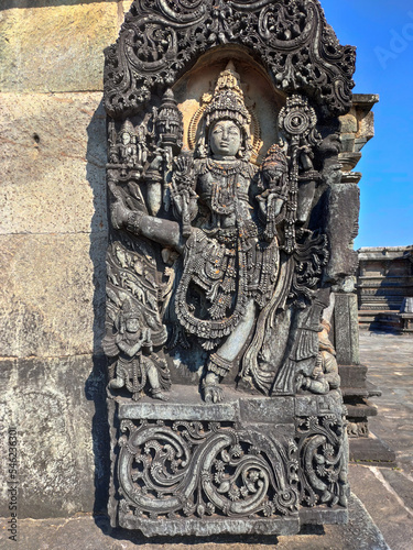 Vamana (Vishnu's avtar) statue on ornate wall panel at Chennakesava temple complex, Belur, Karnataka, India photo