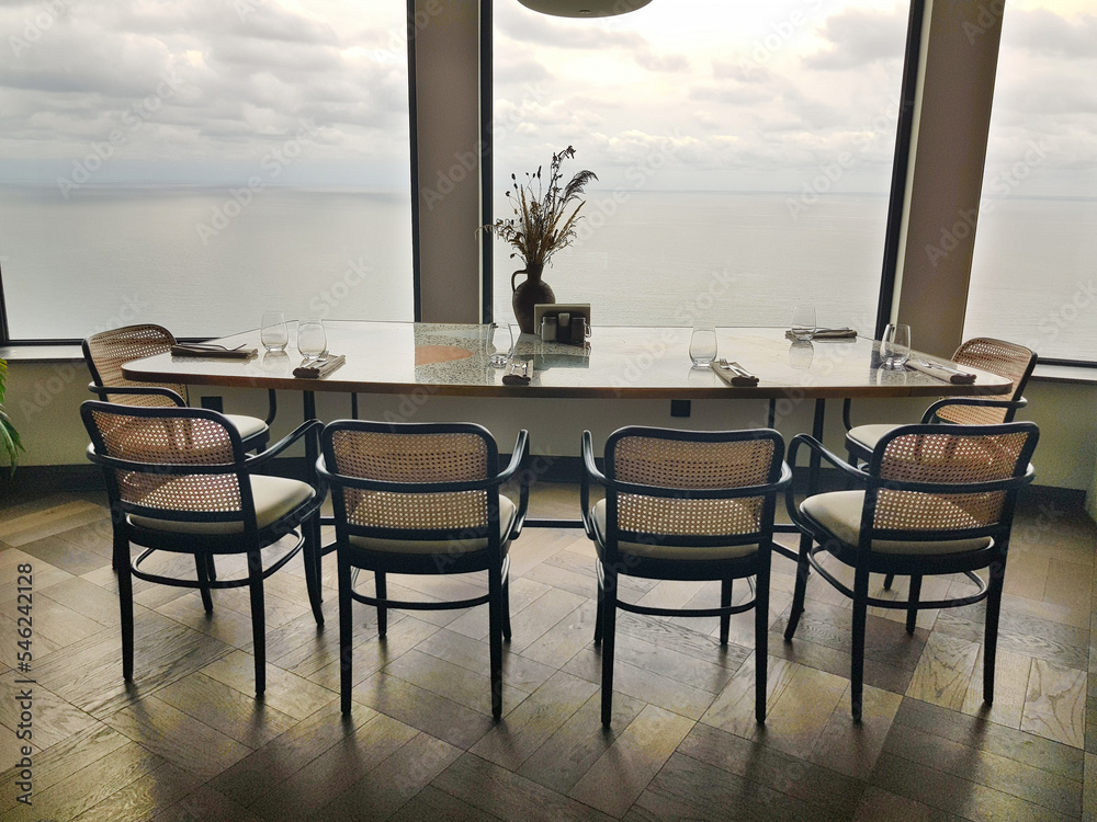 Restaurant table with chairs and panoramic windows