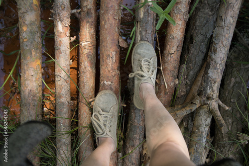 Woman is walking on a wooden pier
