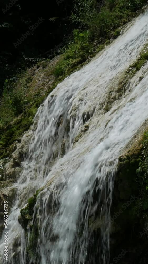 Steady, close up of water cascading down a beautiful waterfalls Steady, close up of water cascading down a beautiful waterfalls