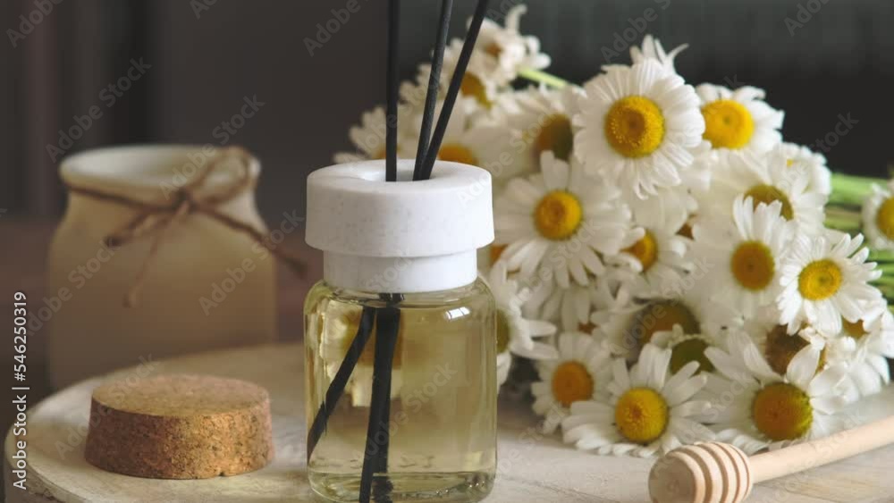 Chamomile flavour air freshener, home aroma fragrance diffuser in bed over. Healthy lifestyle and interior elements