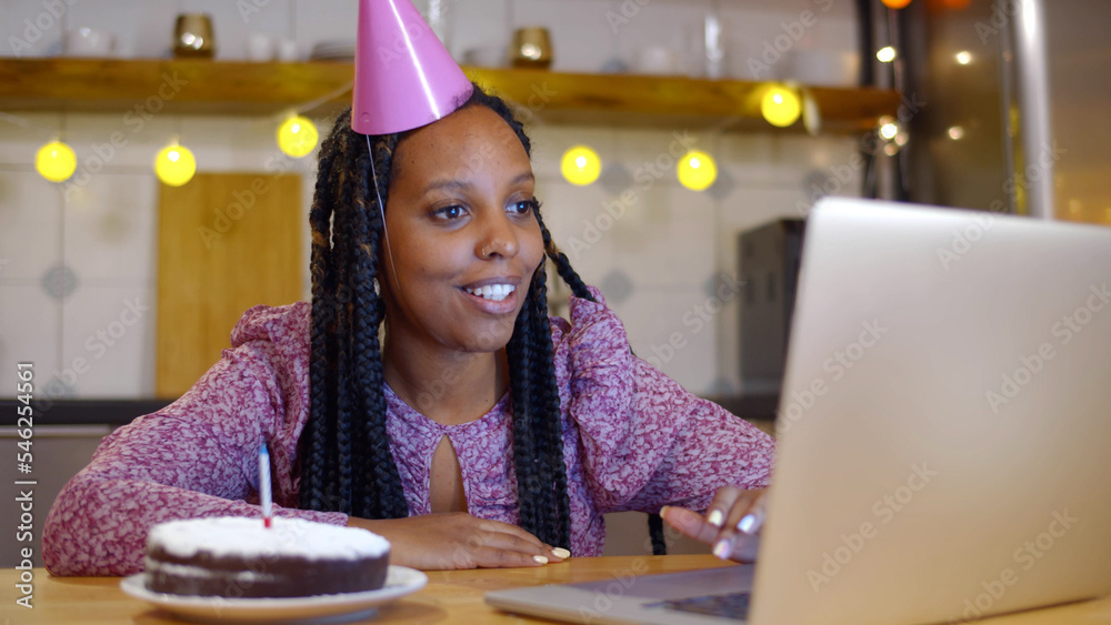 African-American woman celebrating her birthday through video call virtual party with friends. African-American woman celebrating her birthday through video call virtual party with friends.