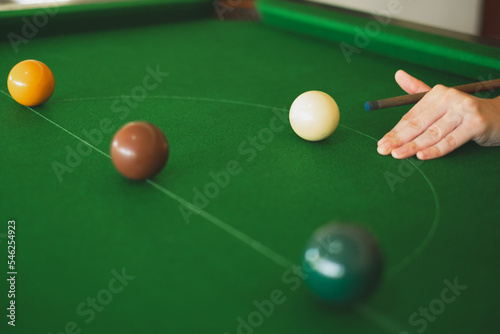 Hand's of snooker is going to take a shoot. Concept of playing activity, entertainment leisure, billiards, snooker or pool ball. Blue chalk. Hobbies and lifestyles. photo