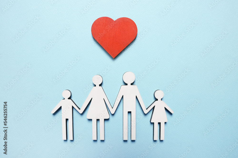 Figures of family and heart on light blue background, top view. Insurance concept Figures of family and heart on light blue background, top view. Insurance concept