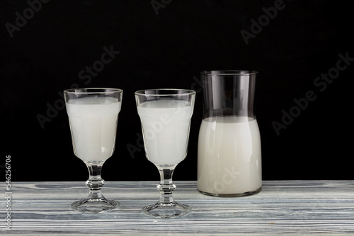 Homemade fermented alcoholic plant-based drink on dark background. Fermented beverages made by soaking grain, rice or fruits in water