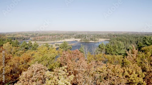 Au Sable River in Michigan during fall colors with drone video moving forward over trees. photo