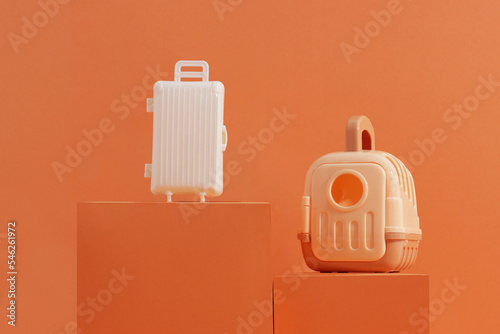 Concept travel or moving with animal, flight, safety. Plastic cage, pet carrier and suitcase on orange background (ID: 546261972)