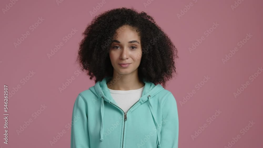 Close up shot of single, beautiful, young woman with positive facial expression. Portrait of a brunette, mixed race lady nodding. High quality 4k footage Close up shot of single, beautiful, young woman with positive facial expression. Portrait of a brunette, mixed race lady nodding. High quality 4k footage